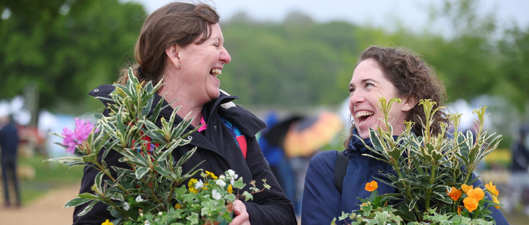 Two people hold planters with a selection of plants in them from the BBC Gardeners' World Spring Fair Two people hold planters with a selection of plants in them from the BBC Gardeners' World Spring Fair